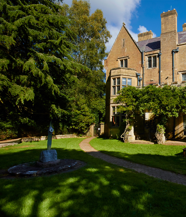 A lush garden with building in the background