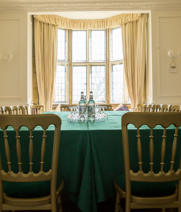 Tables and chairs positioned for a meeting with glasses and bottles of water.