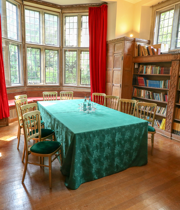 Tables and chairs positioned for a meeting with glasses and bottles of water.