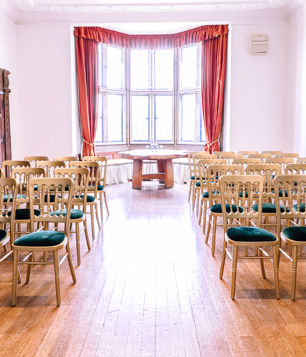 Chairs positioned for an event with a large window in the background.