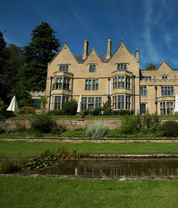 Pond and garden with a large building in the background