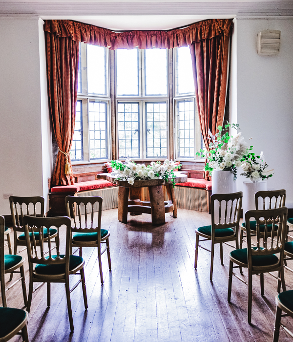 A wedding ceremony with a centre table and floral decorations