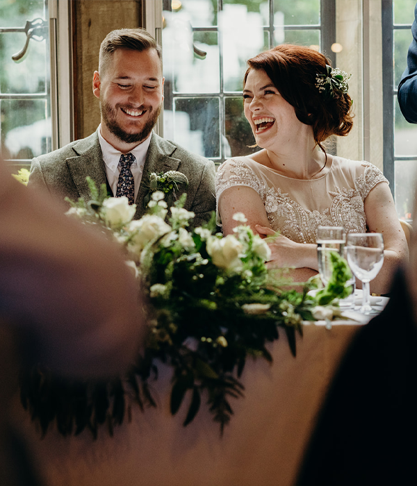 Bride and Groom sitting at a table