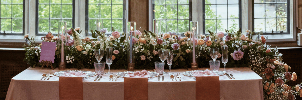 Floral arrangement on a head table for a wedding.