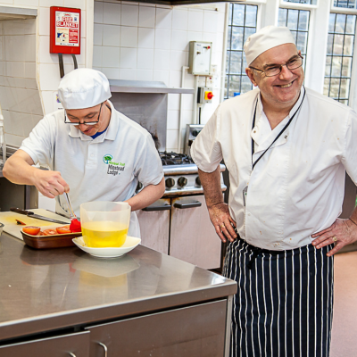 Two people working in the kitchen showing how our team support people with learning disabilities.